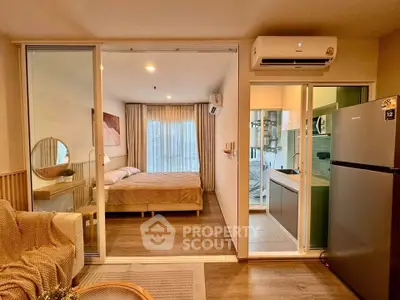 Modern studio apartment with open layout, featuring cozy bedroom, stylish living area, and sleek kitchen.