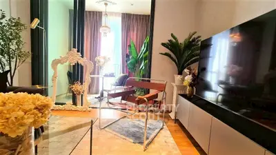 Stylish living room with modern decor, large TV, and elegant furnishings.