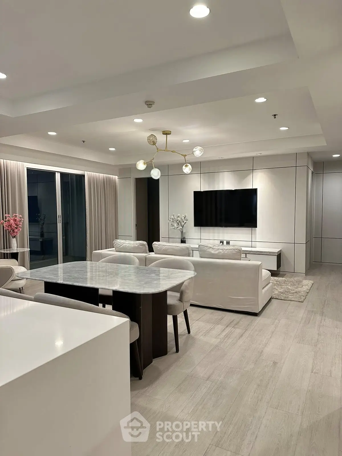 Luxurious modern living room with elegant dining area and stylish lighting in open-concept layout.