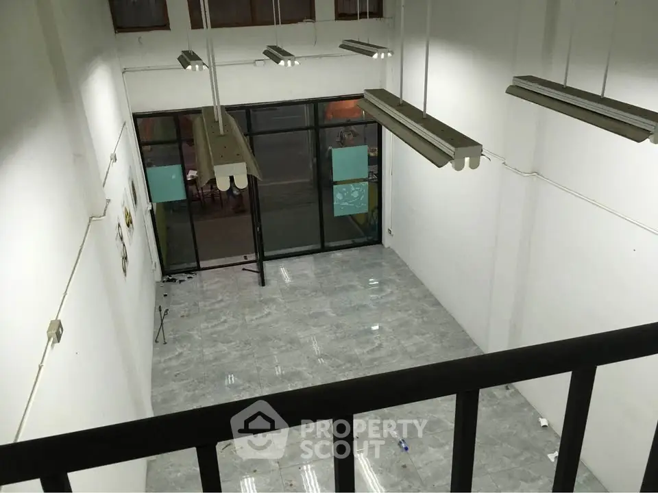 Spacious commercial space with high ceilings and modern lighting, ideal for retail or office use.