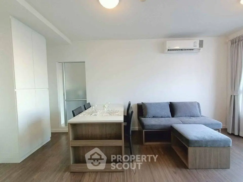 Modern living room with sleek furniture and air conditioning, perfect for comfortable living.