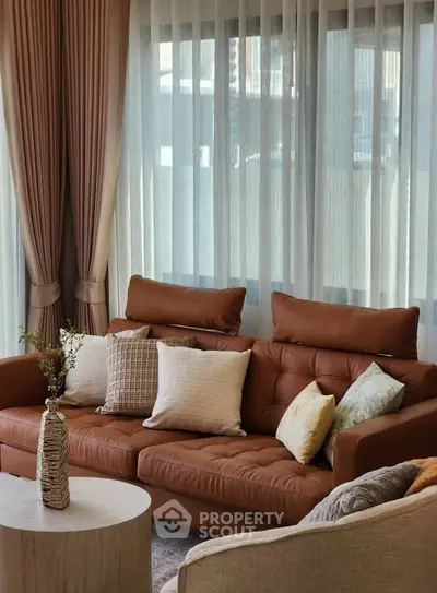 Elegant living room with brown leather sofa and stylish decor
