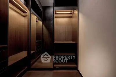 Luxurious walk-in closet with elegant wooden finishes and ample storage space.