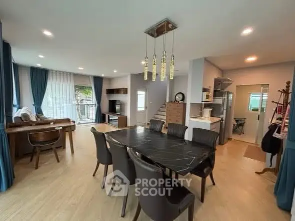 Spacious open-plan living and dining area with modern furnishings and natural light.