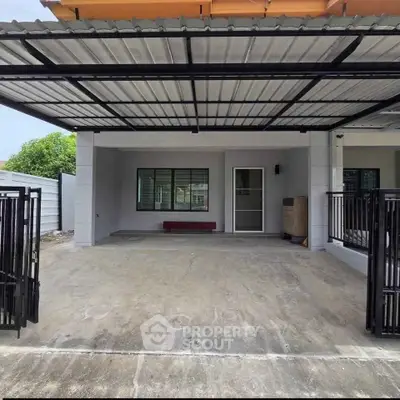 Modern single-story house with covered carport and gated entrance, ideal for family living.