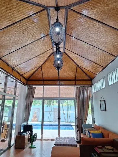 Stunning living room with pool view and unique ceiling design