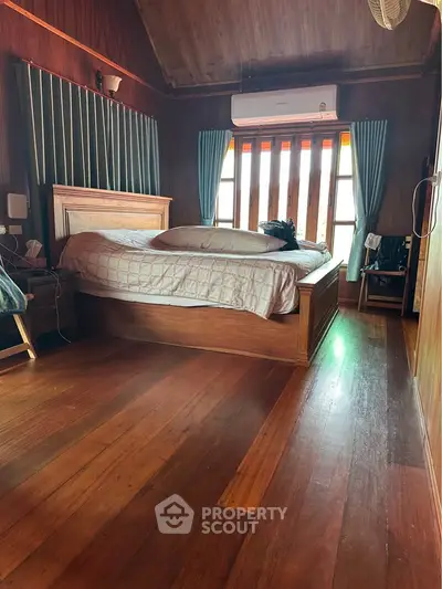 Cozy wooden bedroom with natural light and air conditioning