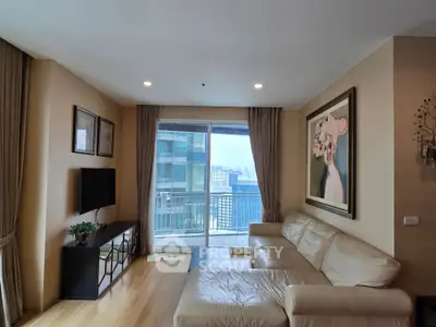 Spacious living room with modern decor and balcony view in high-rise apartment