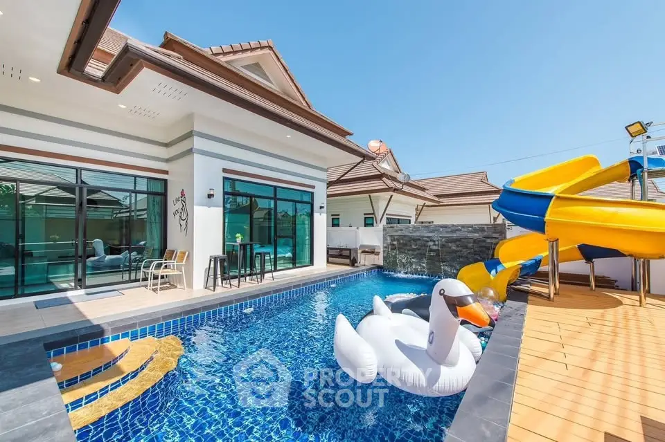 Luxurious villa with private pool and slide, perfect for family fun and relaxation.