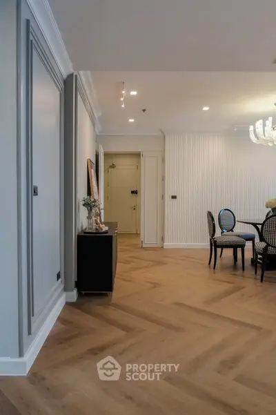 Elegant dining area with herringbone wood flooring and modern decor