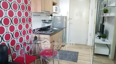 Modern compact kitchen with stylish decor and dining area in a cozy apartment.