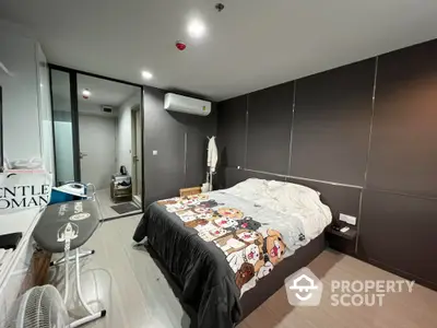 Modern bedroom with stylish decor and air conditioning in a cozy apartment.