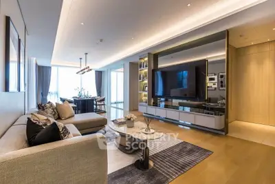 Luxurious modern living room with elegant decor and spacious layout, featuring a large TV and stylish furniture.