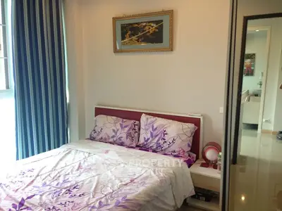 Cozy bedroom with floral bedding and modern decor in a bright apartment.