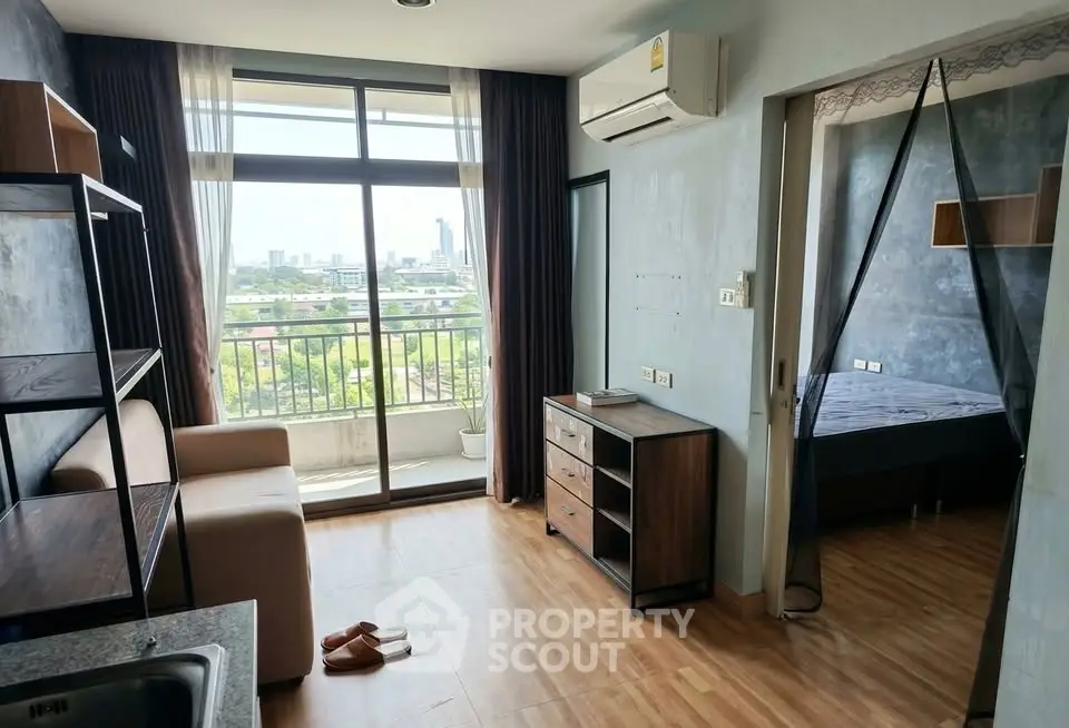 Modern apartment with balcony and city view, featuring stylish living area and bedroom.