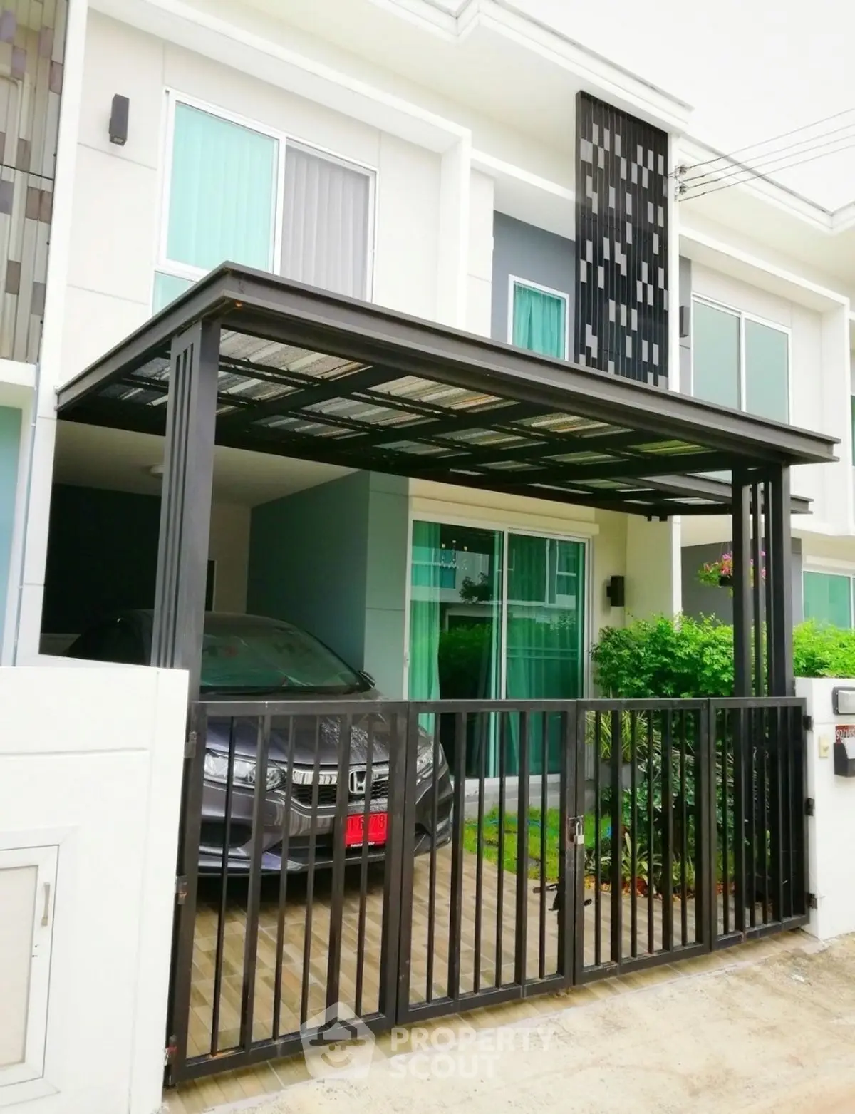 Modern townhouse with covered parking and sleek exterior design