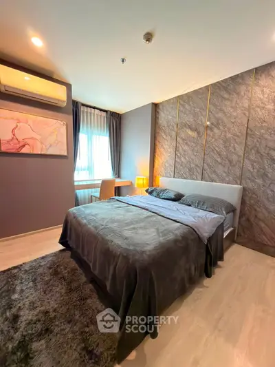 Luxurious bedroom with modern decor and natural light in a stylish apartment.