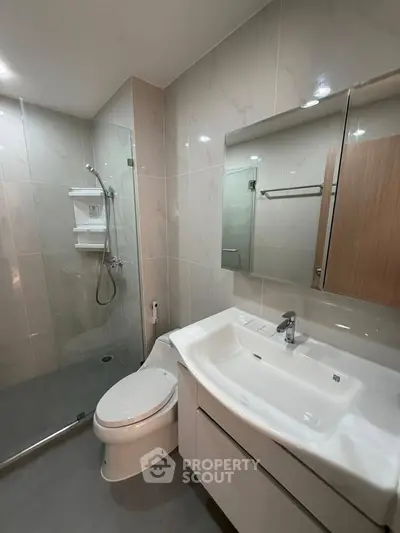 Modern bathroom with sleek fixtures and glass shower enclosure