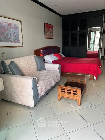 Cozy bedroom with stylish decor and comfortable seating area