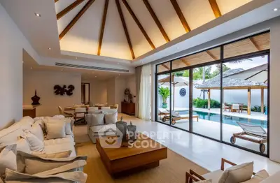 Luxurious open-plan living room with pool view and elegant wooden ceiling