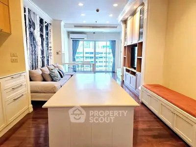Spacious living room with modern decor and large windows offering city view
