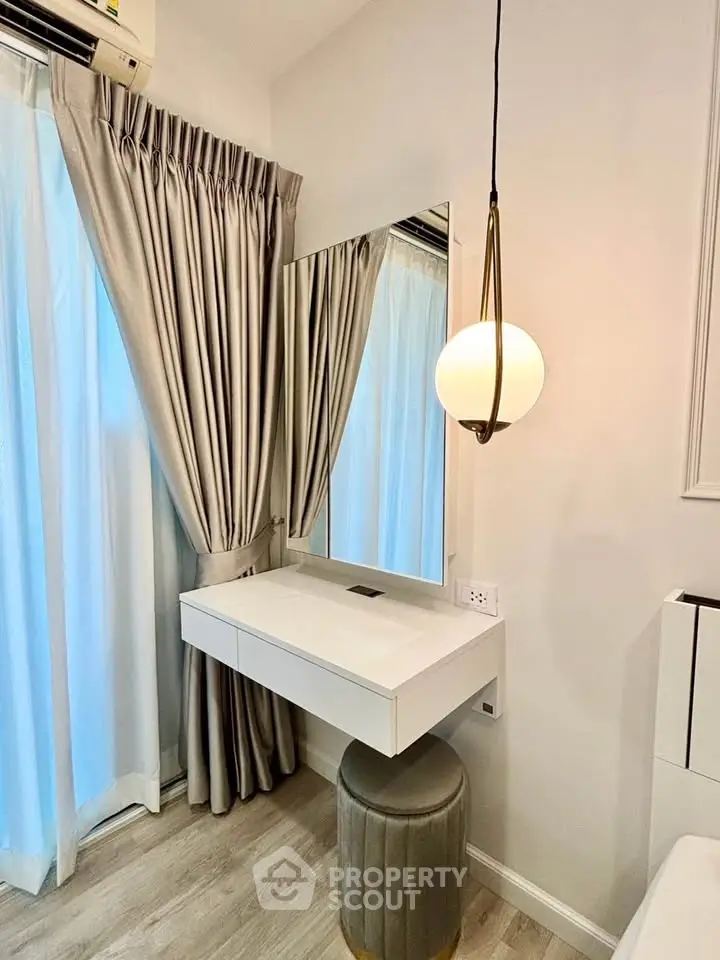 Elegant bedroom corner with modern vanity and stylish lighting