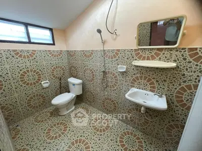 Spacious bathroom with unique tile design and modern fixtures