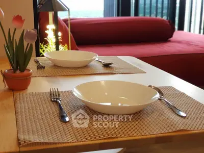 Cozy dining setup with a view, featuring elegant tableware and a comfortable seating area.