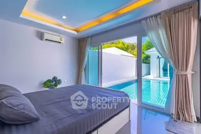 Luxurious bedroom with pool view and modern decor in a serene setting.