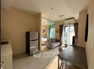 Modern apartment interior with open layout, featuring a cozy living area and dining space with natural light.
