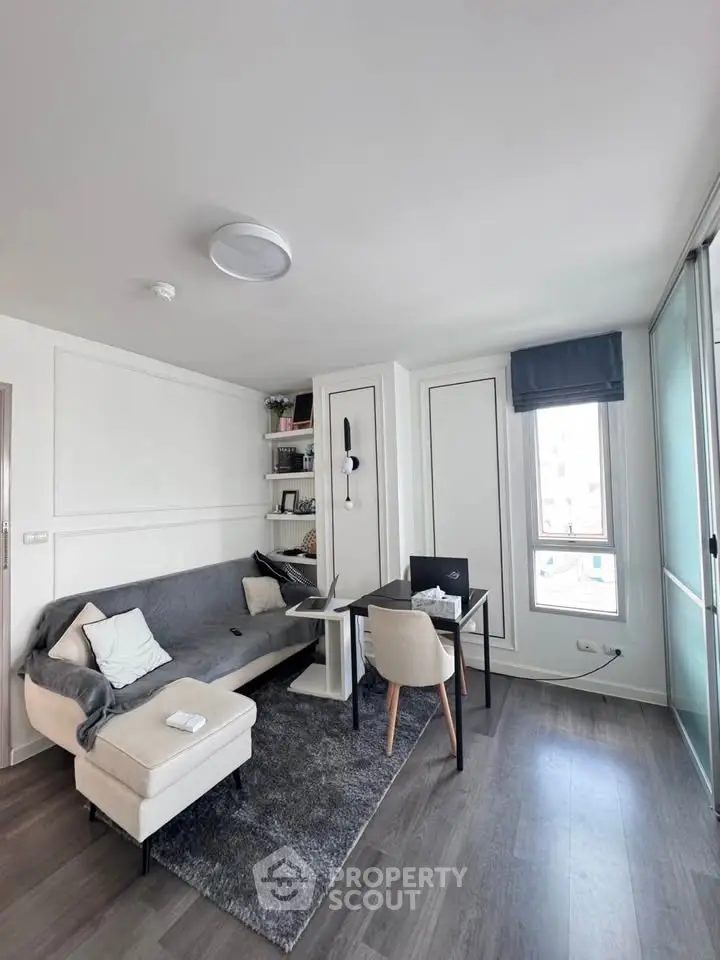 Modern living room with sleek furniture and natural light, perfect for urban living.