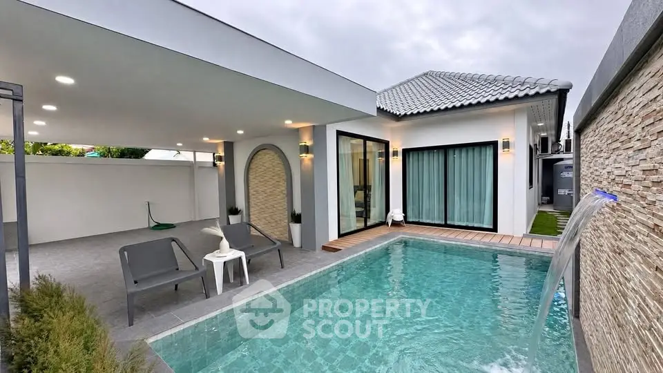 Modern villa with private pool and stylish outdoor seating area, perfect for luxury living.