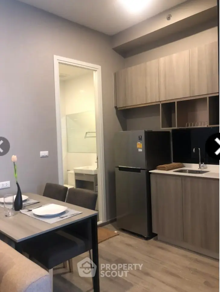 Modern compact kitchen with dining area and sleek cabinetry