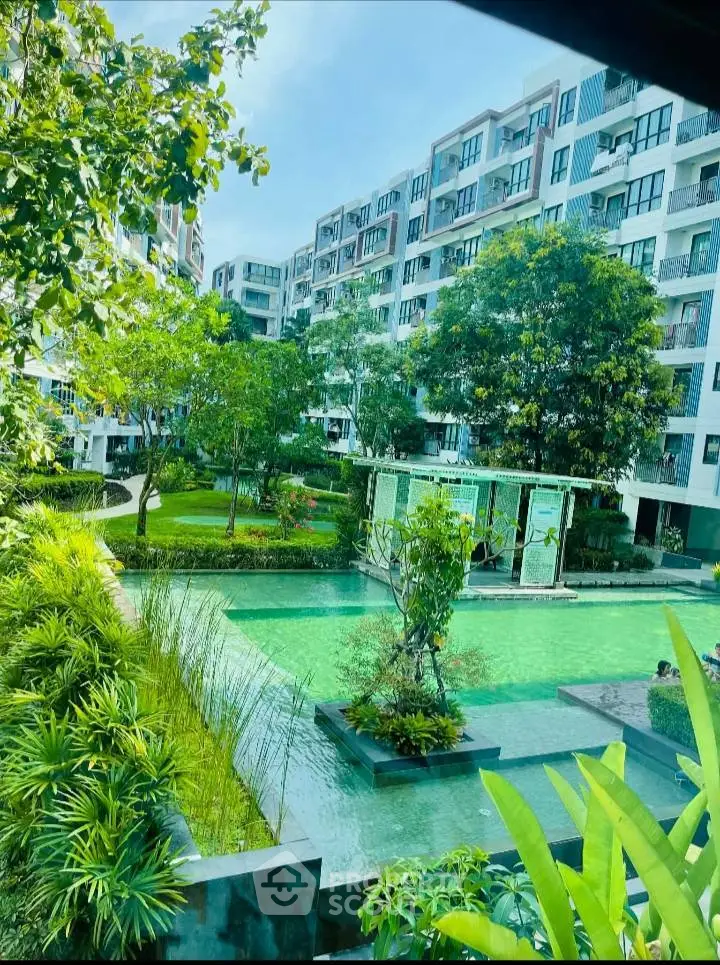 Luxurious apartment complex with lush garden and serene water feature