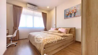 Cozy bedroom with wooden flooring and elegant decor