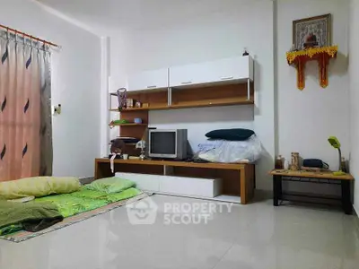 Cozy living room with minimalist decor and TV unit, perfect for relaxation.