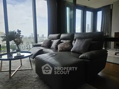Luxurious living room with panoramic city view and modern furnishings.
