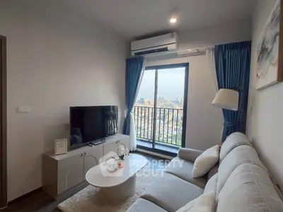 Modern living room with city view, cozy sofa, and stylish decor in a high-rise apartment.