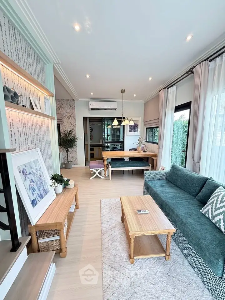 Stylish living room with modern decor, large windows, and cozy seating area.