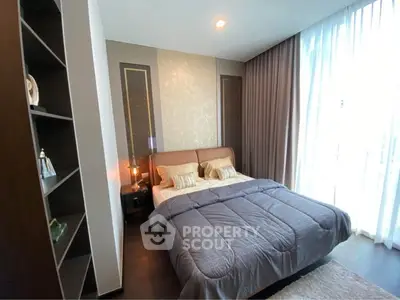 Luxurious bedroom with elegant decor and large window for natural light.
