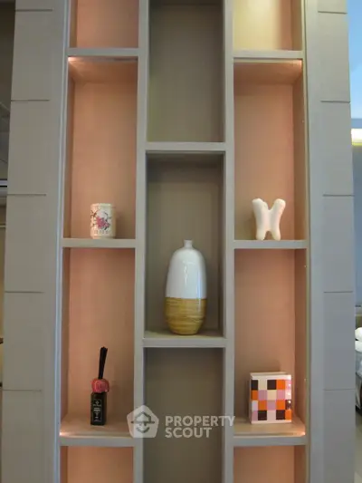 Elegant interior shelving with decorative items in a modern living space.
