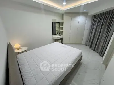 Modern bedroom with sleek design, featuring a cozy bed, built-in wardrobe, and elegant lighting.