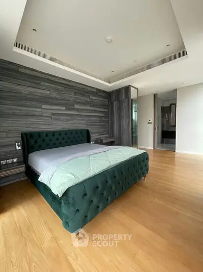 Luxurious bedroom with elegant green velvet bed and modern wood paneling