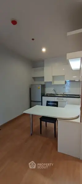 Modern kitchen with sleek cabinetry and integrated dining table
