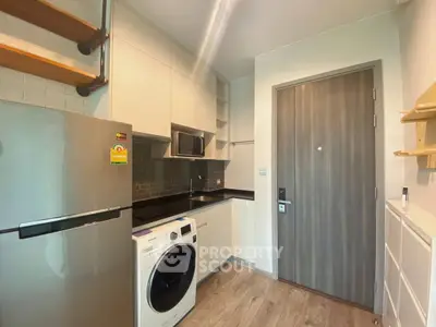 Modern kitchen with sleek appliances and wooden accents