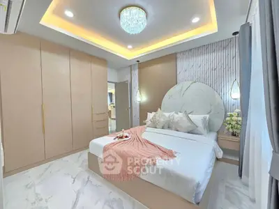 Luxurious bedroom with elegant lighting and modern decor, featuring a cozy bed and stylish wardrobe.