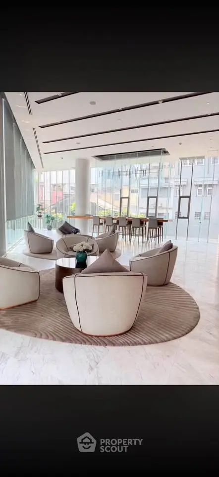 Luxurious modern lobby with elegant seating and panoramic windows in a high-end building.