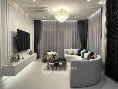 Luxurious modern living room with elegant chandelier and stylish decor