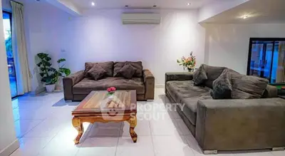 Spacious living room with cozy sofas and elegant decor, perfect for relaxation and entertaining guests.