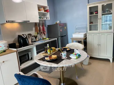 Charming kitchen with modern appliances and cozy dining area, perfect for urban living.